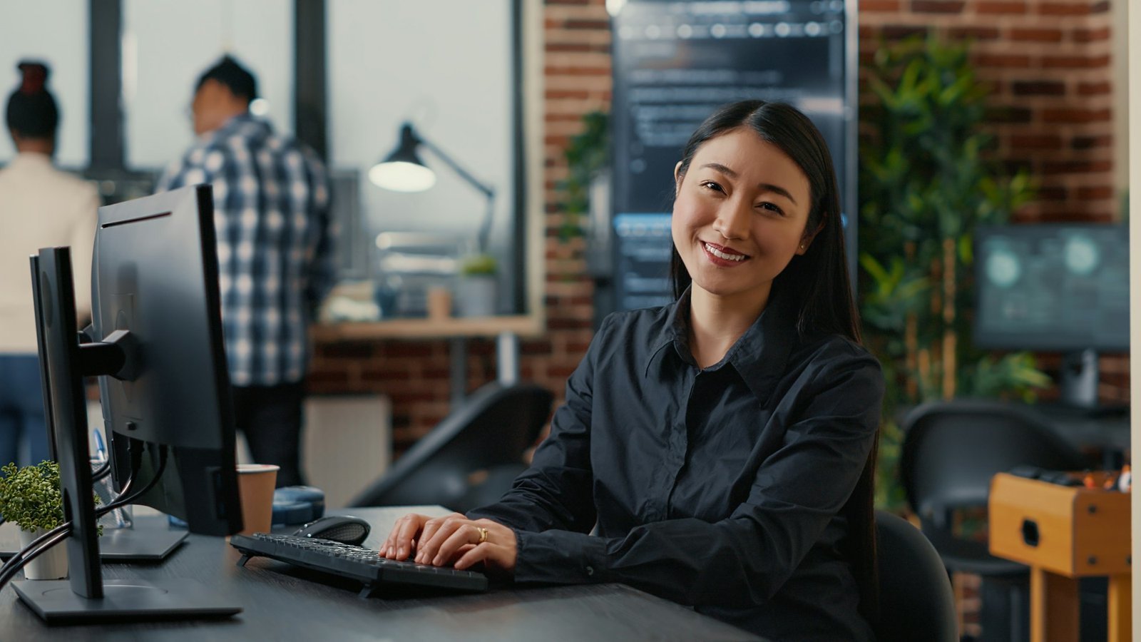 smiling-asian-database-software-developer-writing-programming-code-on-computer-keyboard.jpg